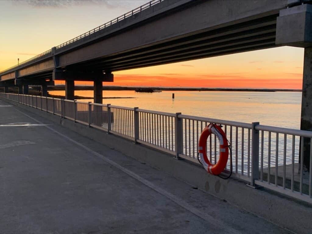Sunrise over the water seen from the Bonner Bridge Pier at Oregon Inlet.