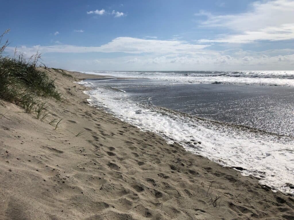 Wind-driven storm surge pushing up against the sandbag dune line on Hatteras Island.
