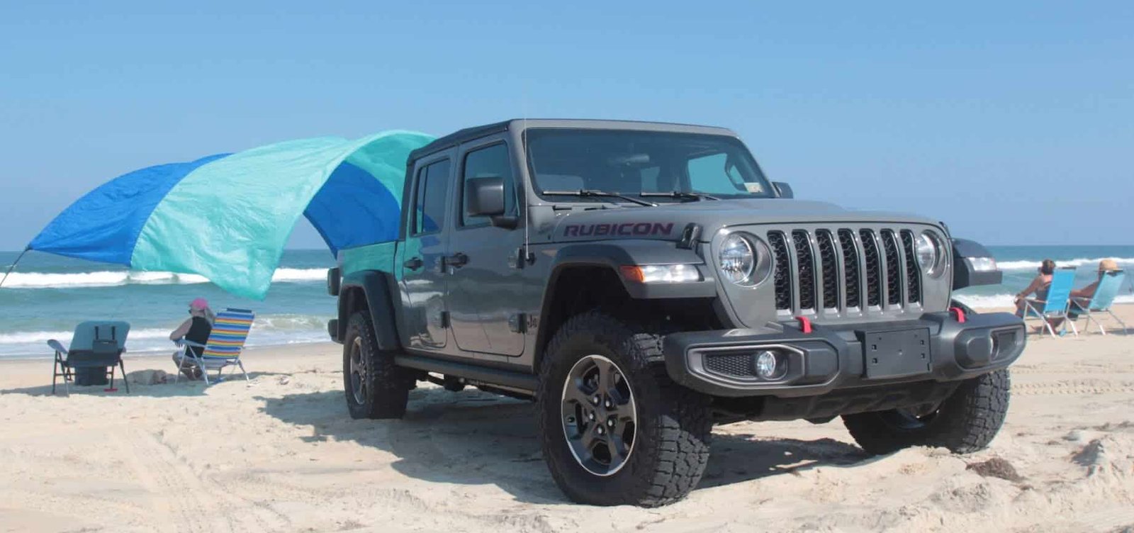 Gray Jeep Gladiator Rubicon rental parked on an Outer Banks beach